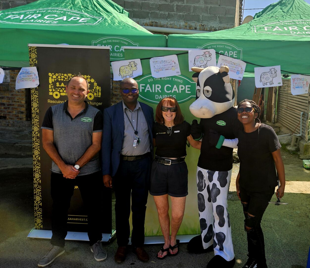 Dan Serman (Fair Cape Foundation), Mr Jaxa (Takalani Educare in Dunoon), Margolite Williams (SA Harvest), Fair Cape cow and Zee Mapoma (SA Harvest)