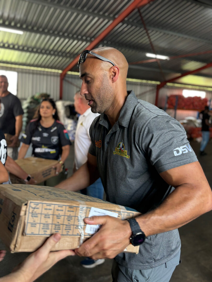 Waylon Murray, Cell C SA Rugby Legend, assisting with the food distribution