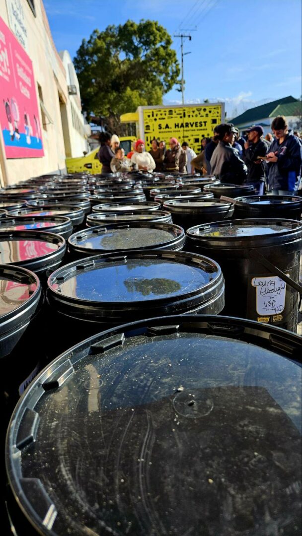 Distributing buckets of nutrition after Mandela Day in 2024