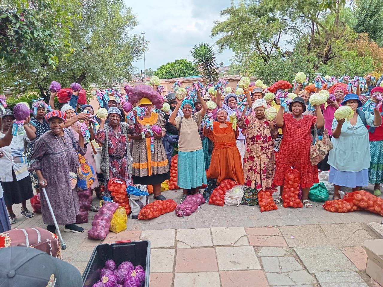 Residents of Itlhokomeleng Old Age Home in Alexandra, Johannesburg, with vegetables received from SA Harvest.